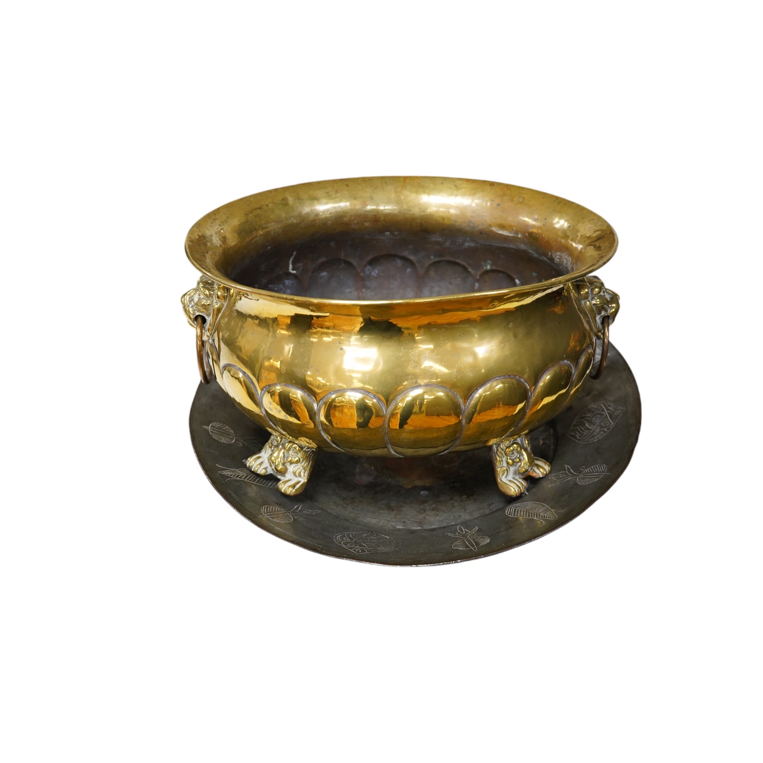 A n18th century style Dutch embossed brass oval jardiniere and a circular metal engraved plaque, jardiniere approximately 40cm wide (2). Condition - plaque rusty at centre, jardiniere fair